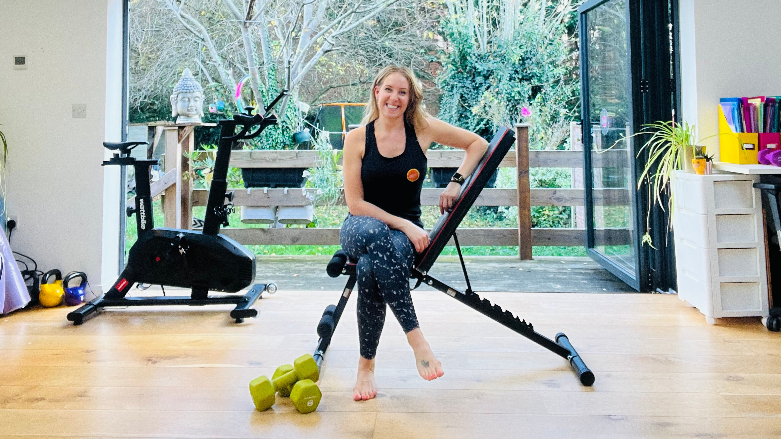 Woman sits on weight bench in domestic setting